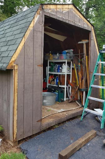 A weather-beaten shed with no door and missing trim