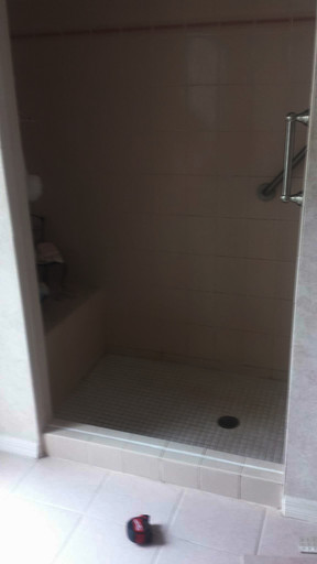 Entrance to a shower with a high curb